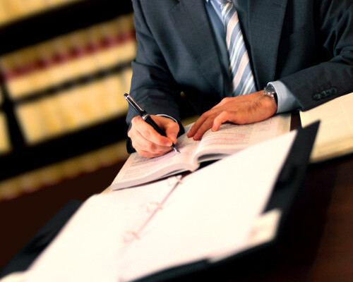 lawyer writing down notes during a personal injury deposition