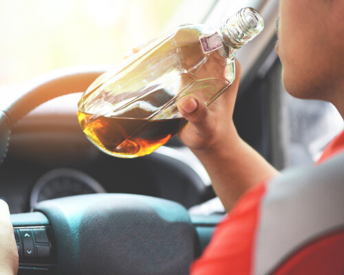 person drinking alcohol while driving and causing an accident